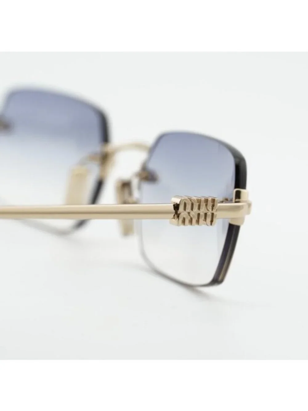Miu Miu MUB50S ZVN80O Sunglasses Gold Rectangle Frame, Light Blue Lenses